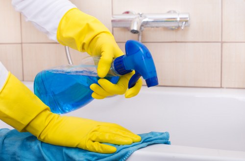 Technician performing hot water extraction on a carpeted floor